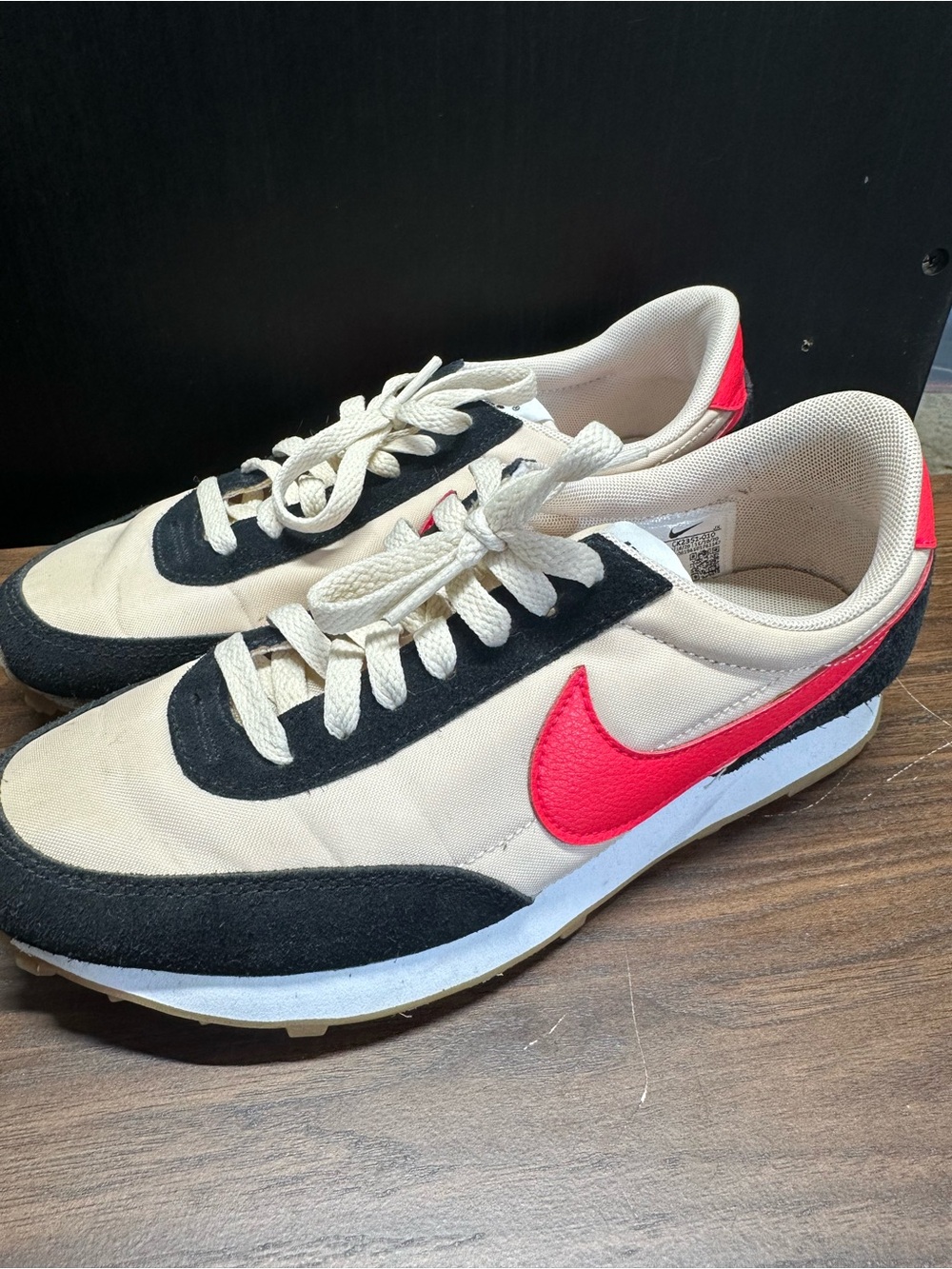 Nike Women’s Beige Black Sneakers with Red Swoosh Accent